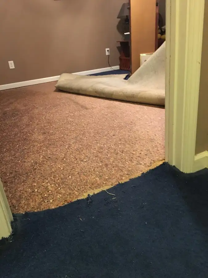 Carpet pad removal revealing water damage during Water Mitigation Services in West Puente Valley